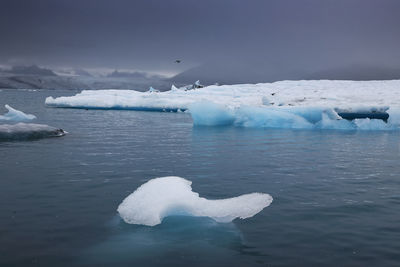 Scenic view of frozen lake against sky