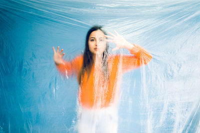 Portrait of teenage girl trapped in plastic