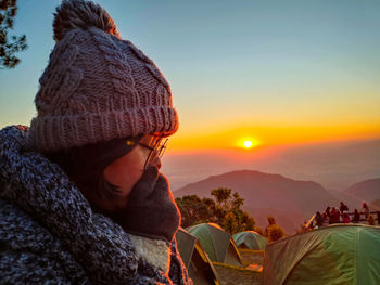 Portrait of woman wearing hat against sky during sunset