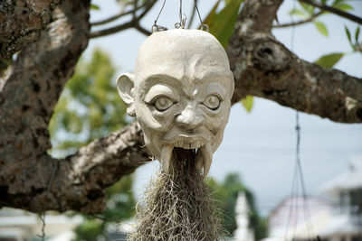 Sculptures of creepy demon and monster heads at white temple