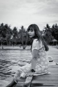 Portrait of young woman sitting on boat