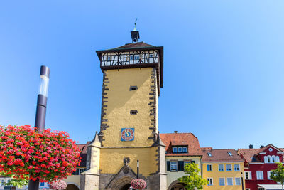 Low angle view of clock tower against clear blue sky