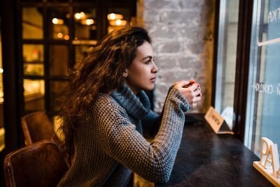 Woman looking down in city