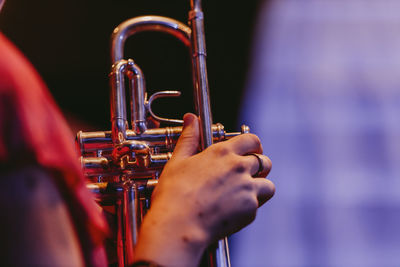 Close up hand holding trumpet