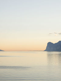 Scenic view of sea against clear sky during sunset