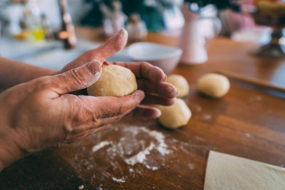 Close-up of person preparing food on table