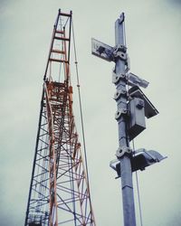 Low angle view of crane against sky