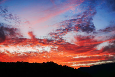 Silhouette of mountain against dramatic sky