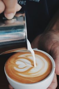 Close-up of hand holding coffee