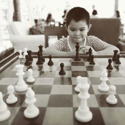 Smiling boy playing chess