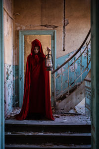 Man standing by door of building