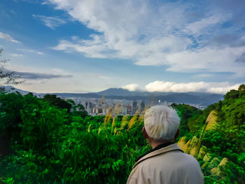 Scenic view of mountains against cloudy sky