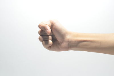 Close-up of woman hand over white background