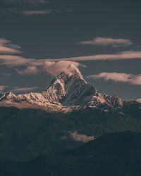 Aerial view of snowcapped mountains against sky during winter