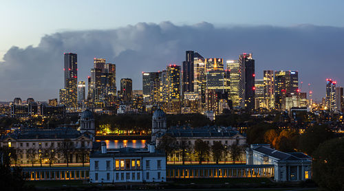 Illuminated buildings against sky at night