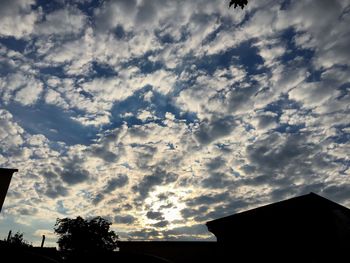 Low angle view of silhouette trees against sky