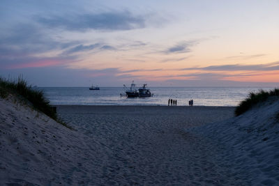 Scenic view of beach against sky during sunset