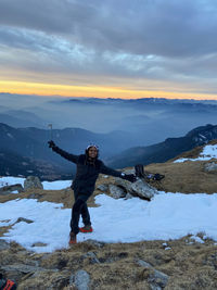 Full length of person on snow covered mountain against sky