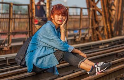 Portrait of young woman sitting outdoors