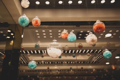 Low angle view of illuminated lanterns hanging on ceiling