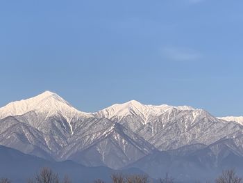 Scenic view of snowcapped mountains against clear sky