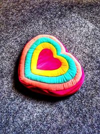 High angle view of multi colored rug on sand