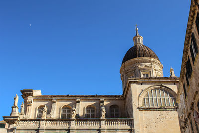 Low angle view of building against clear blue sky