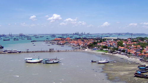 High angle view of boats moored at harbor in city