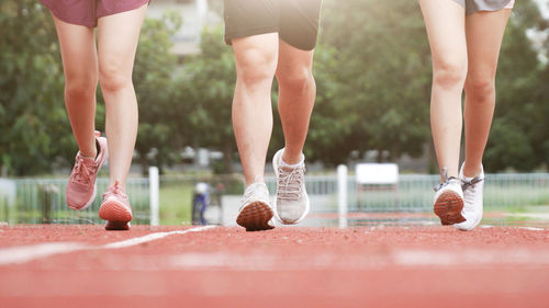 Low section of athletes running at sports track