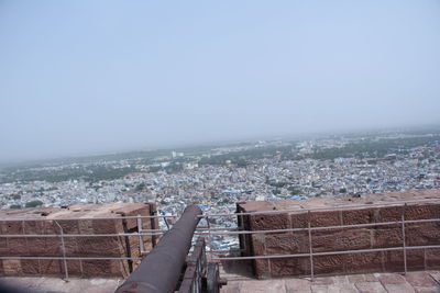 High angle view of townscape by sea against clear sky