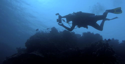 Low angle view of man swimming in sea