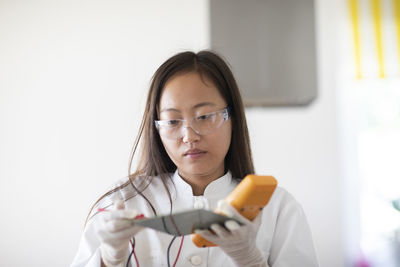 Scientist female with sample and tool in a lab