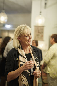 Woman with champagne glass during meeting in cafe