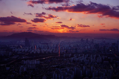 High angle view of modern buildings against sky during sunset