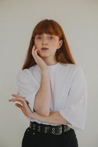 Portrait of young woman sitting at home