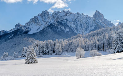 Scenic view of snow covered mountains against sky