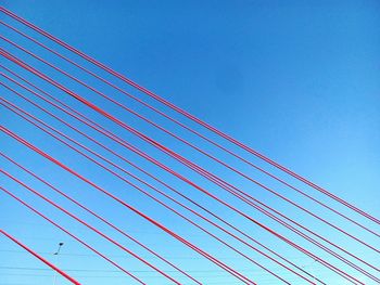 Low angle view of bridge against clear blue sky