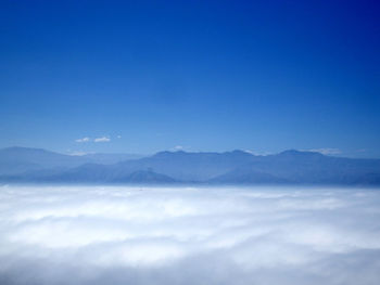 Scenic view of mountains against blue sky