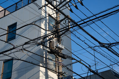 Low angle view of electricity pylon against sky