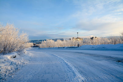 Snow covered landscape against sky