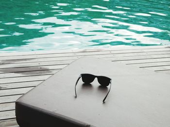 High angle view of sunglasses on swimming pool