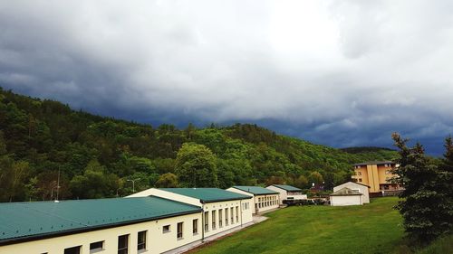 Buildings by swimming pool against sky