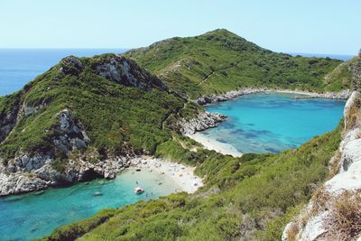 High angle view of sea and mountains against clear sky