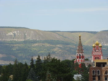 Panoramic view of trees and buildings against sky