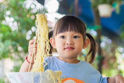 Portrait of cute girl holding outdoors