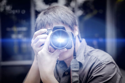 Portrait of man holding camera