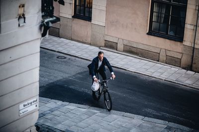 Man riding bicycle on street in city