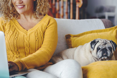 Young woman with pug at home