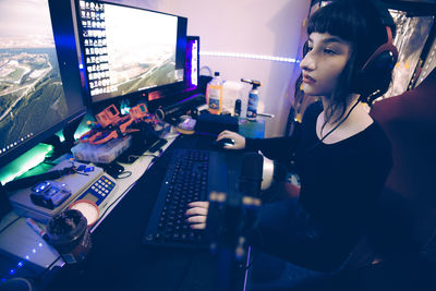 A young woman streamer posing for the camera to showcase her streaming skills.