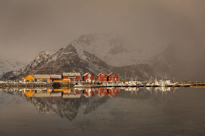 Scenic view of lake with boats against mountain